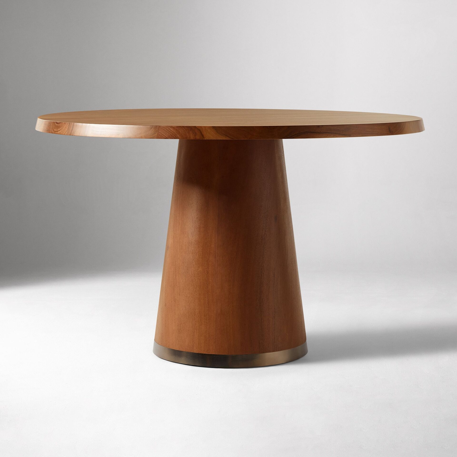 ALDERA solid teak round dining table handcrafted in Jepara with a sculptural pedestal base.