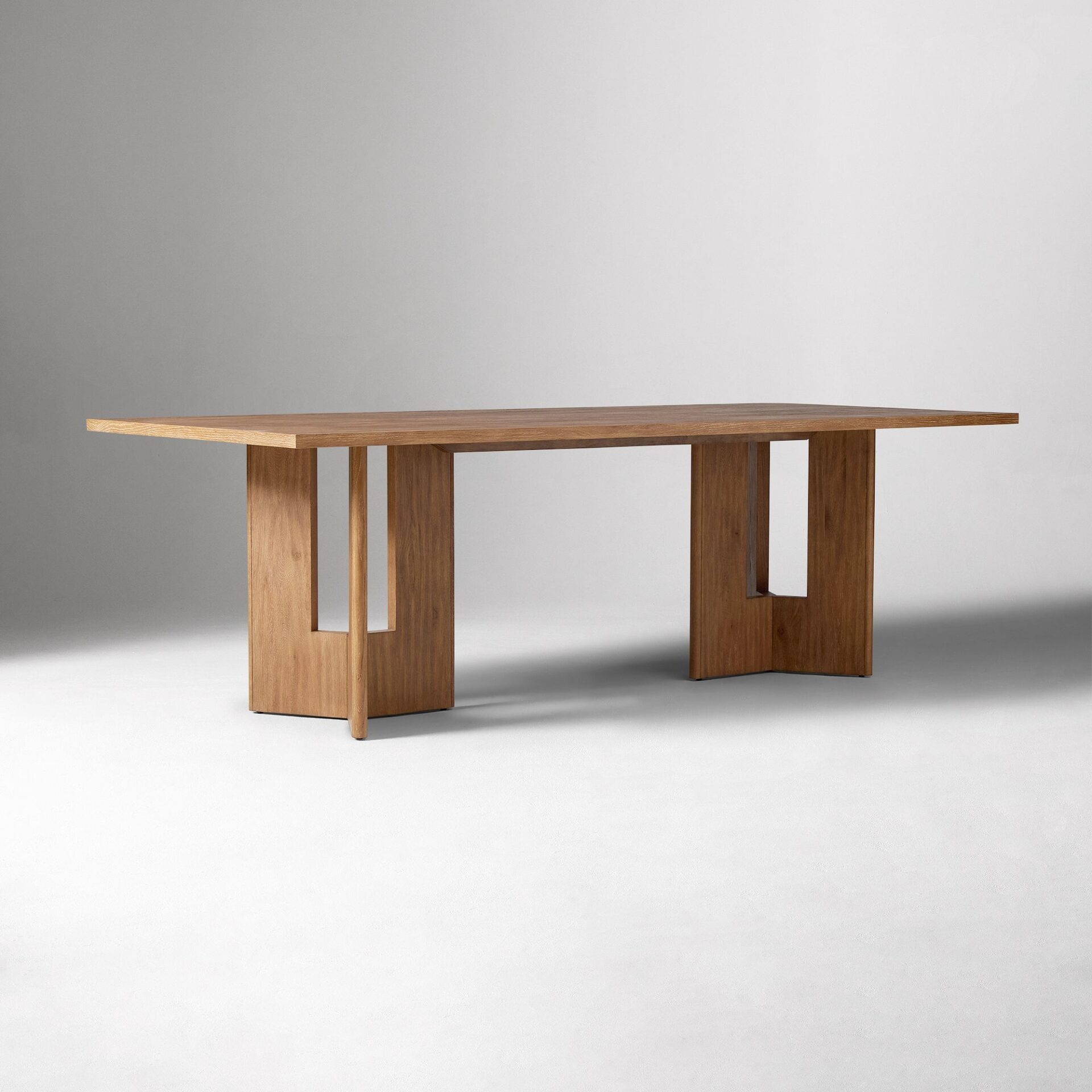 LUMORA solid teak wood dining table handcrafted in Jepara with architectural cut-out panel legs.
