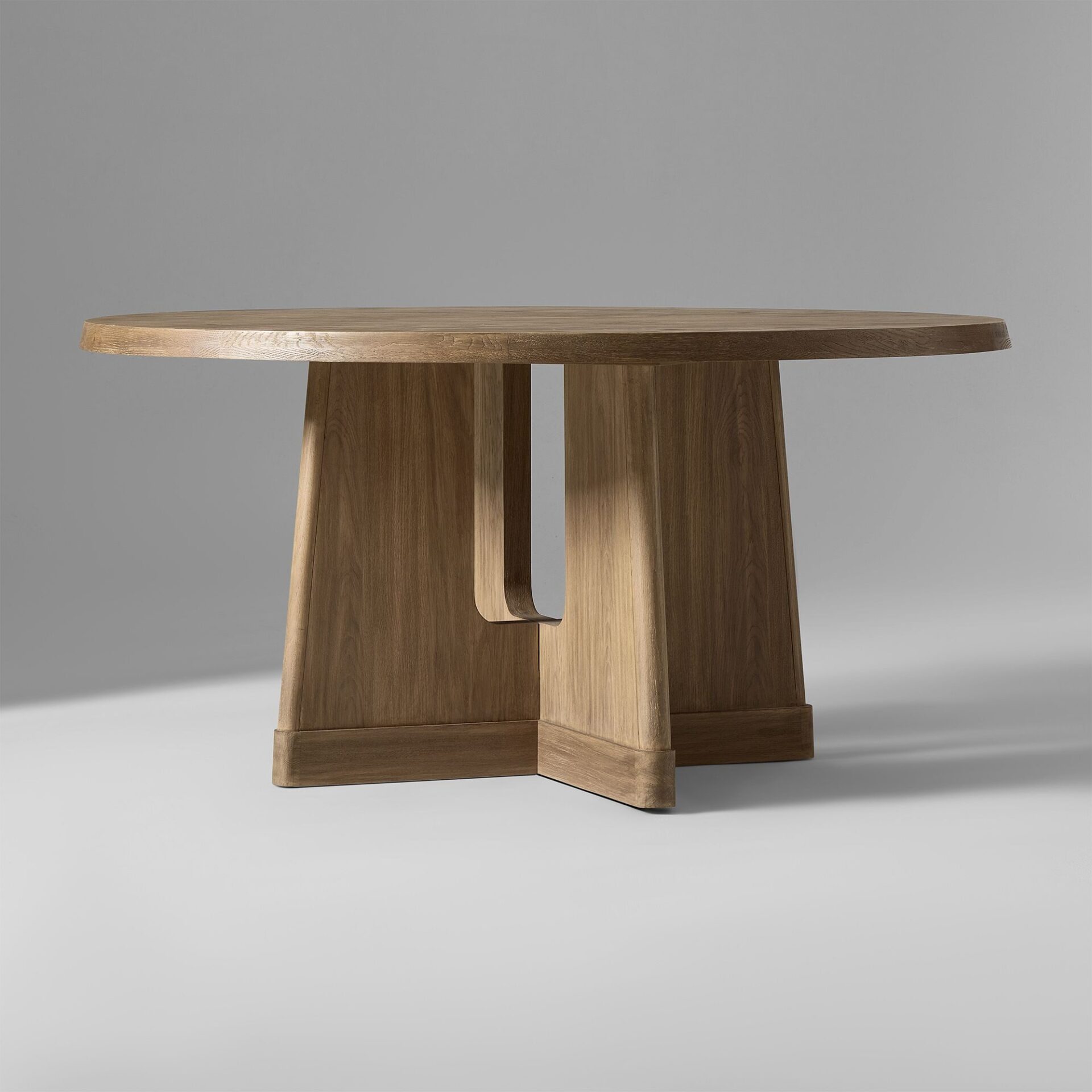 LORIEN solid teak round dining table handcrafted in Jepara with a sculptural pedestal base.