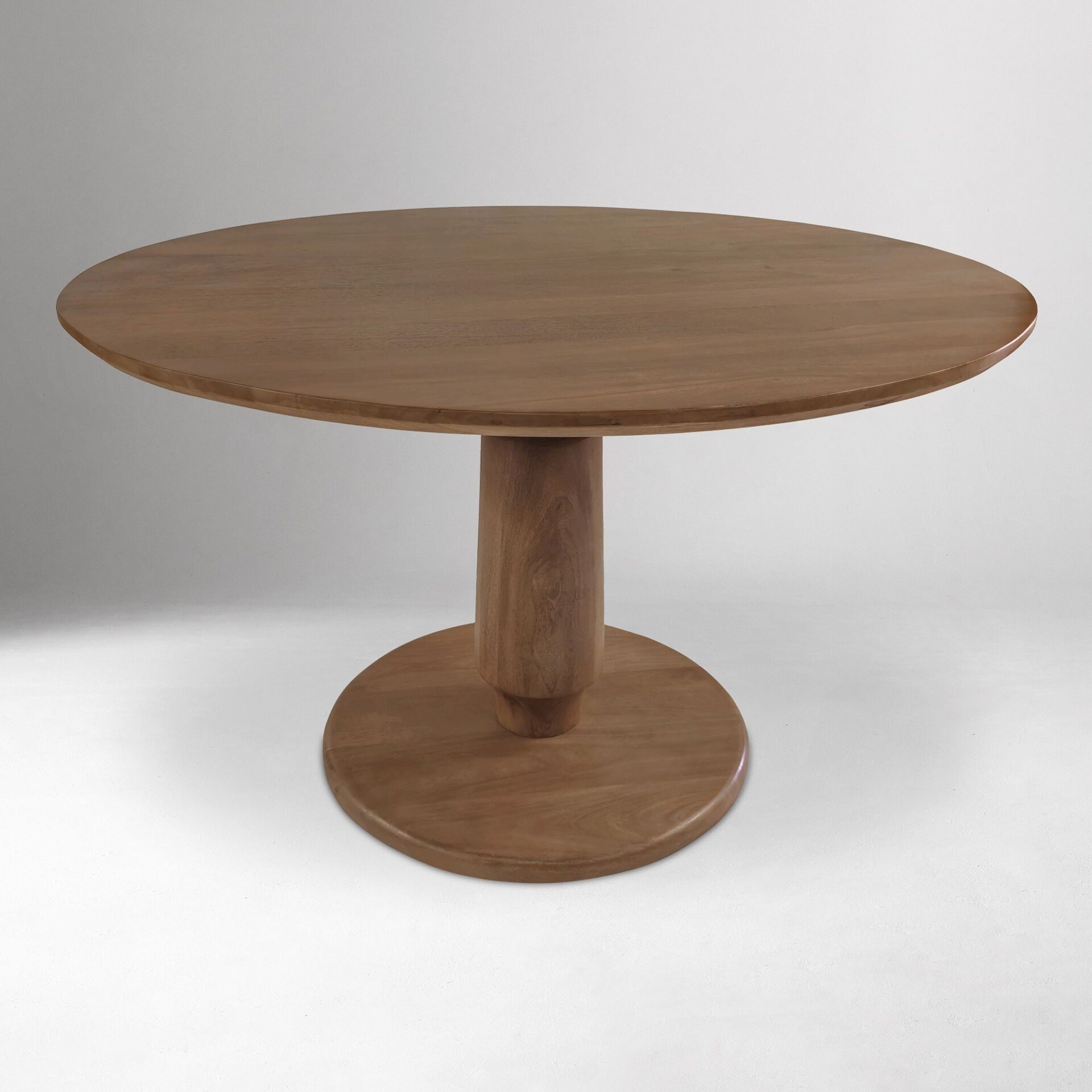 ORBELLE solid teak round dining table handcrafted in Jepara with a sculptural pedestal base.